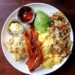 Breakfast plate of eggs, avocado, and bacon