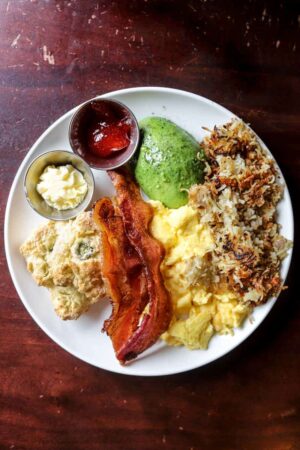 Breakfast plate of eggs, avocado, and bacon